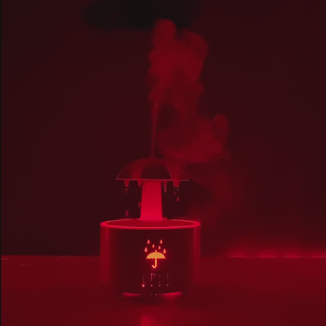 Person relaxing beside MieKit Raindrop Aromatherapy Diffuser with essential oils
